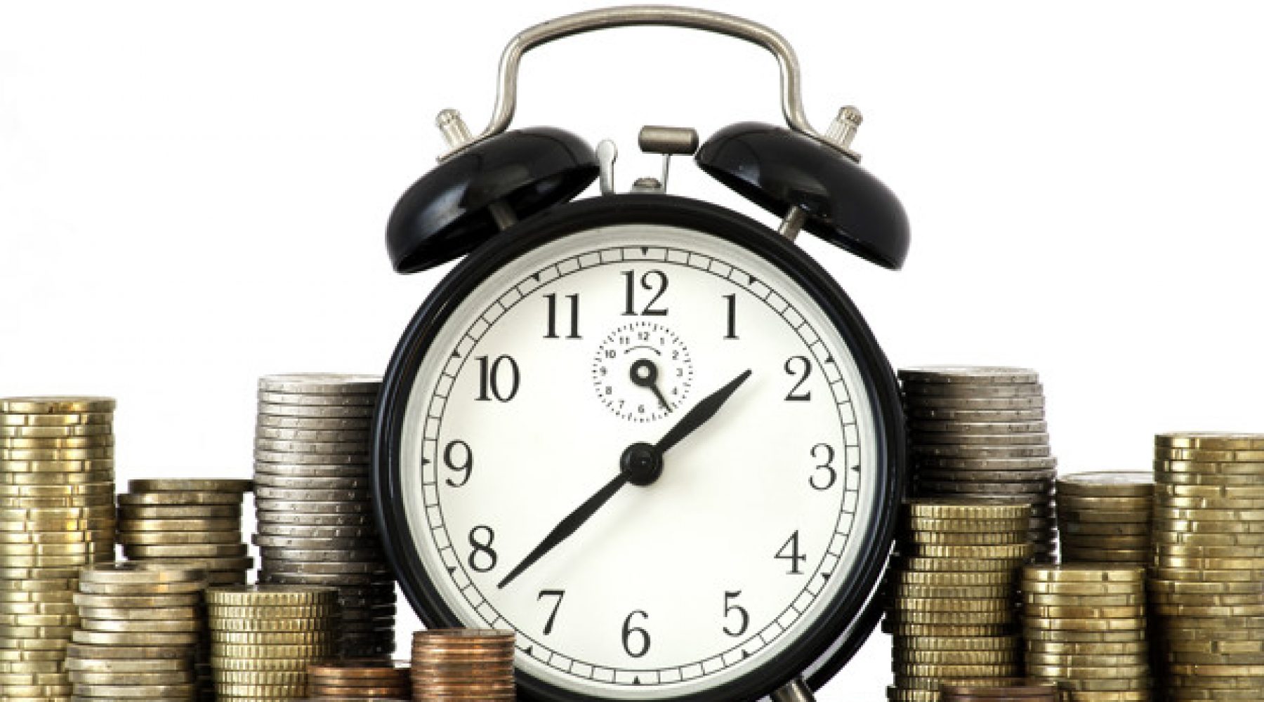 Alarm clock standing with coins on metal plate